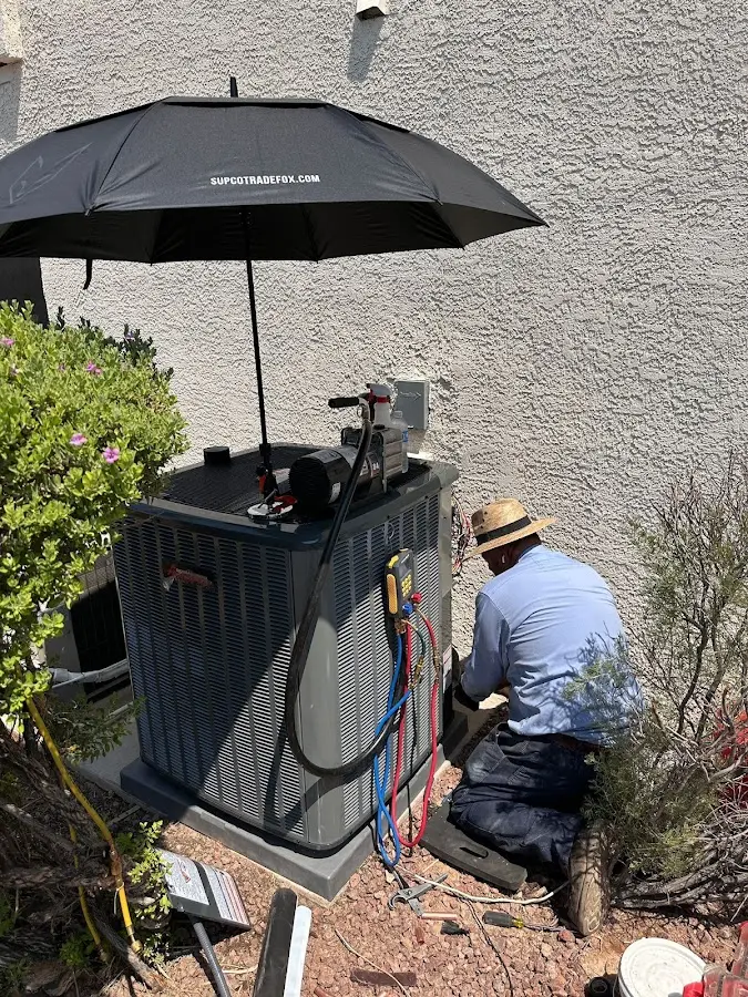 HVAC technician performing outdoor AC maintenance in Basehor